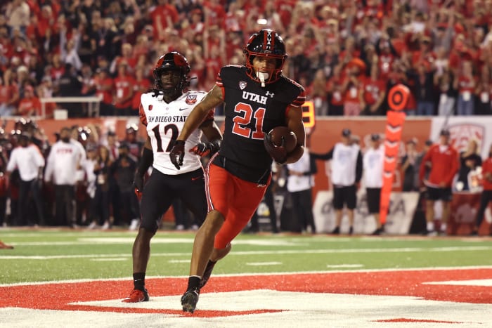 Utah Utes wide receiver Solomon Enis (21) scores a touchdown against San Diego State Aztecs cornerback Dallas Branch (12) in the second quarter at Rice-Eccles Stadium.